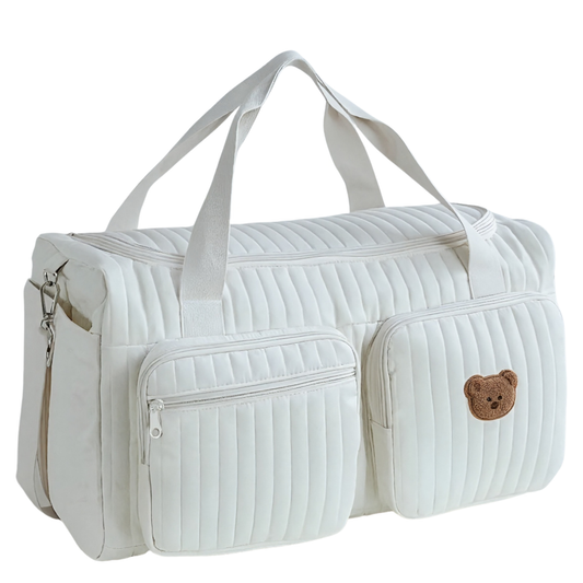 White quilted duffel bag with a bear emblem on a white background