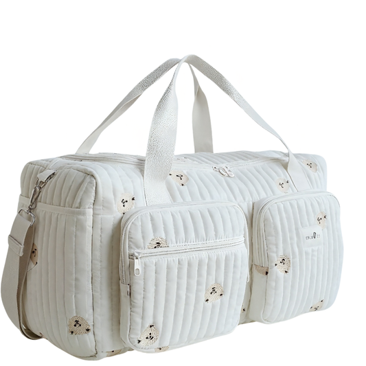 White quilted duffel bag with floral patterns on a white background